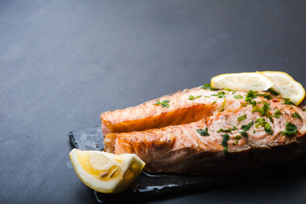 istock Salmon slice with a lemon and green parsley 997481902
