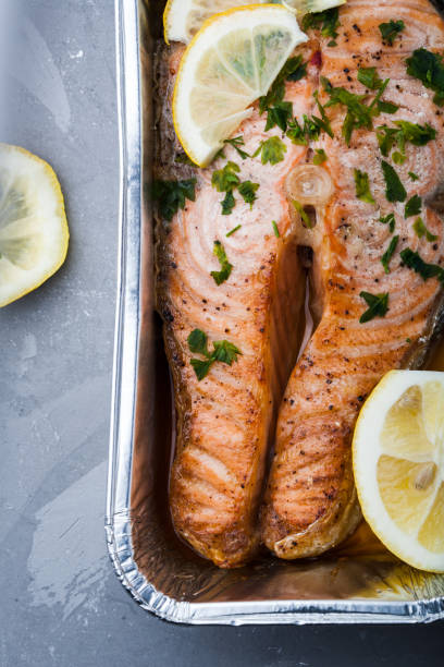 istock Salmon slice with a lemon and green parsley 997481904