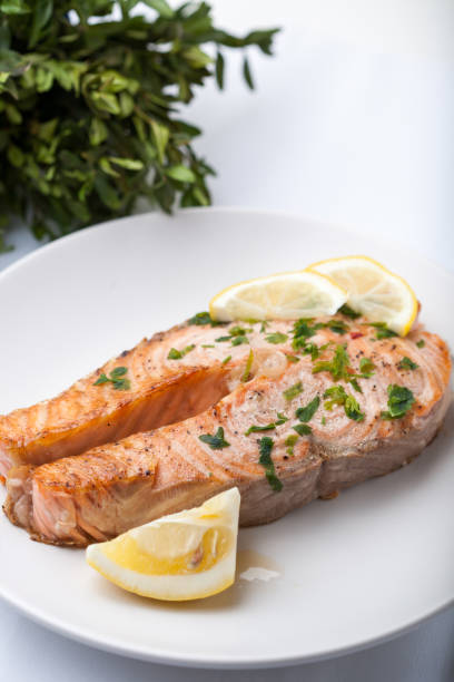 istock Salmon slice with a lemon and green parsley 997482108