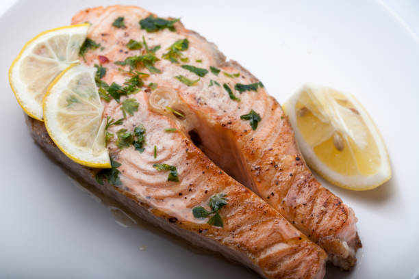istock Salmon slice with a lemon and green parsley 997482312