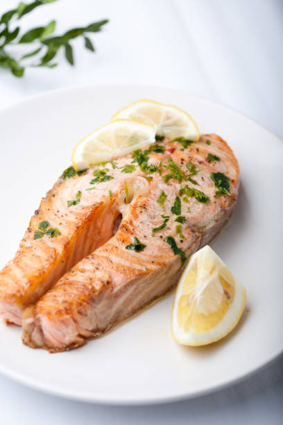 istock Salmon slice with a lemon and green parsley 997482354