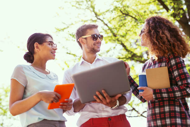 istock Smiling male student holding his laptop 997482938