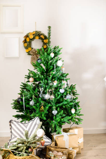 istock Beautifully decorated Christmas tree with presents under it in t 997487550