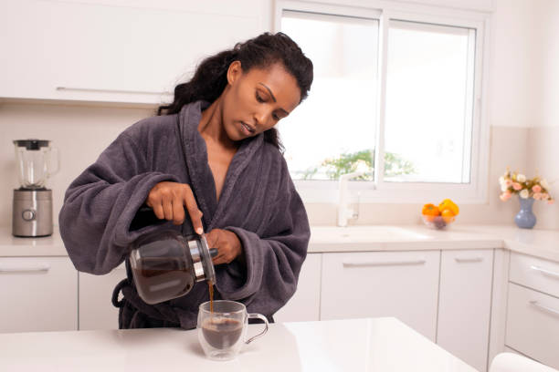 istock Woman enjoying fresh coffee at home kitchen. 997490488