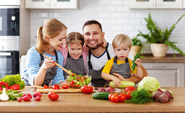 istock appy family with child  preparing vegetable salad 997490842