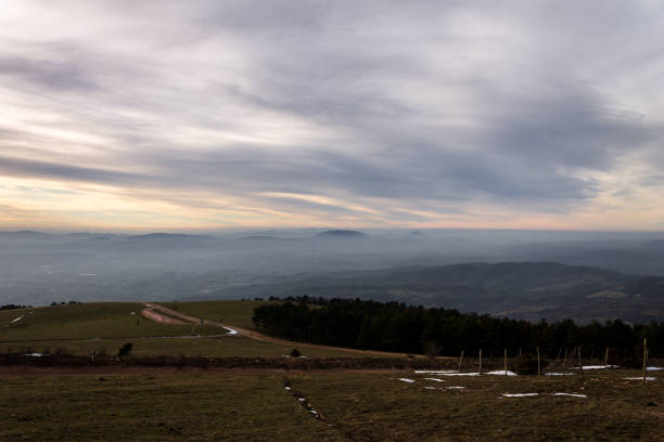 istock Subasio Mt. (Umbria, Italy), with sky covered by clouds and warm sunset colors 997491172