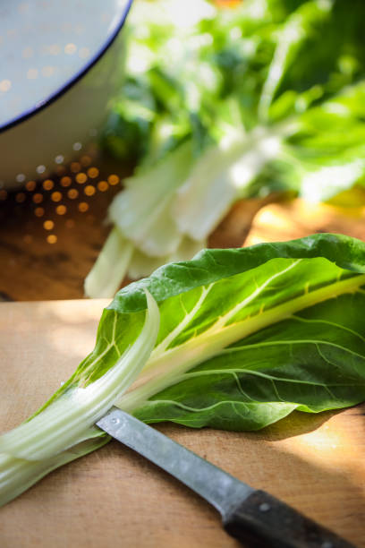 istock Fresh Green Chard Leaves on table outdoor 997497636
