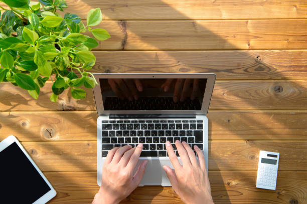 istock Laptop and wood table 997508240