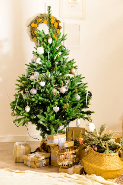 istock Beautifully decorated Christmas tree with presents under it in t 997513818
