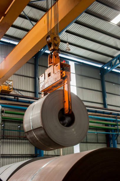 istock Crane loading of metal steel rolls 997517744