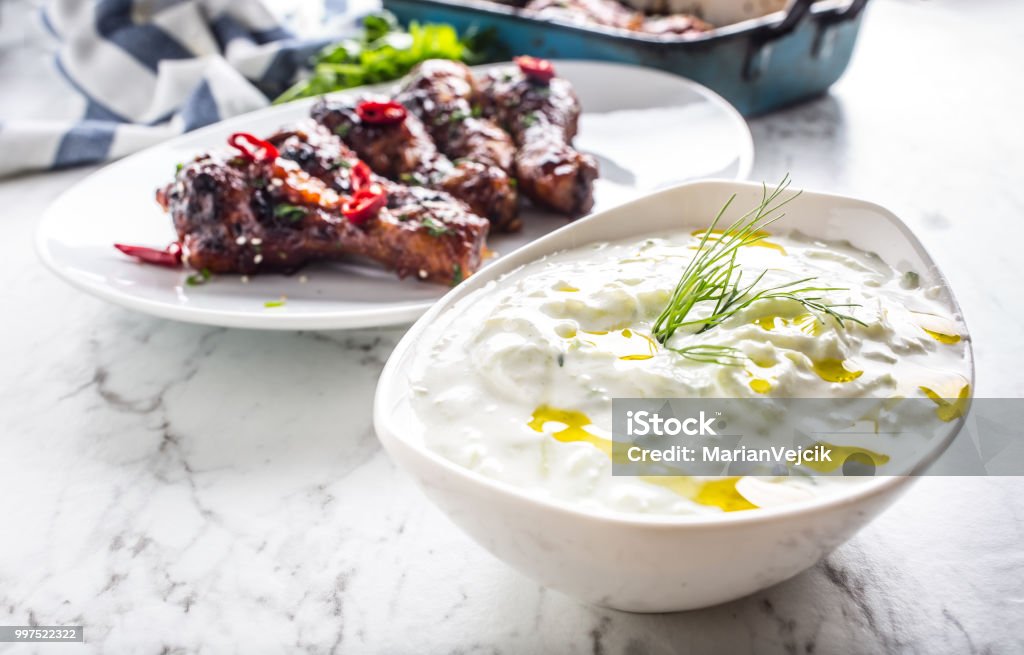 Greek dip sauce or dressing tzatziki with chicken legs. Appetizer Stock Photo