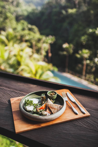 istock Eastern breakfast with poached eggs, tomatoes, couscous, eggplant and spicy sauce in a ceramic plate on a wooden stand 997522392
