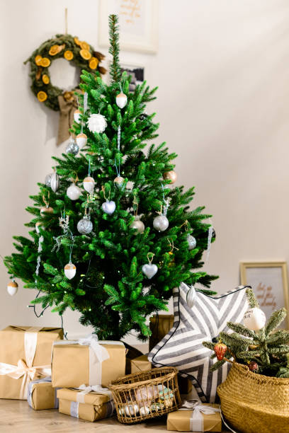 istock Beautifully decorated Christmas tree with presents under it in t 997523440