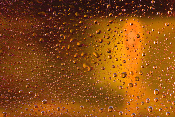 istock Drops of water on yellow surface. Macro abstract photo, backgrou 997524102