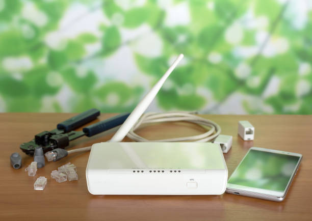 istock Wi-Fi router and smartphone, accessories and crimper for connection on table 997528162