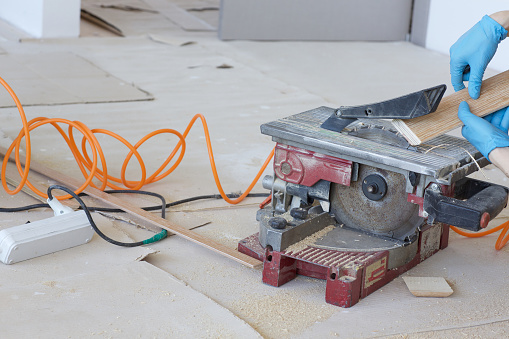 Woodworking machine with circular blade for cutting plinth. Closeup