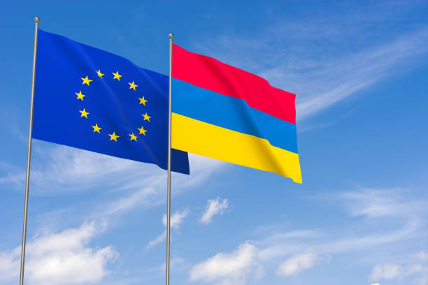 istock European Union and Armenia flags over blue sky background 997531318