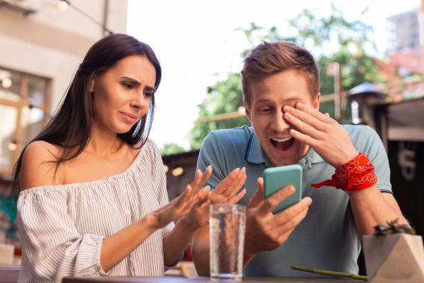 istock Modern man laughing out loud while watching old photos 997537100