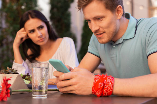 istock Modern man wearing red floral wrist band using his smart phone 997539556
