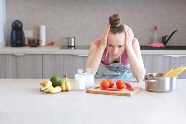 istock Young woman stays in the kitchen 997540038