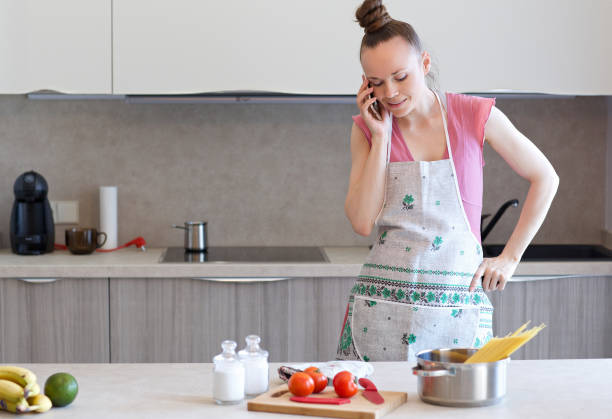 istock Young woman stays at kitchen table 997541172