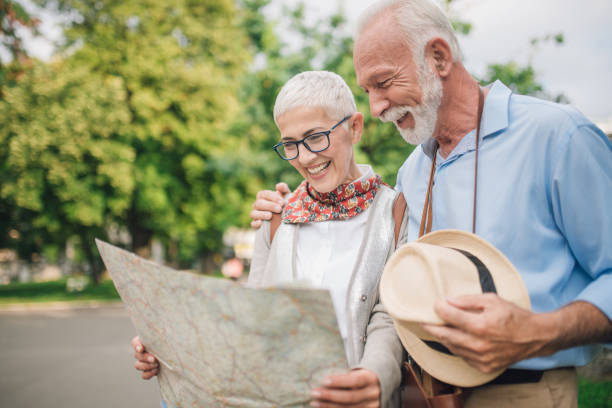 istock Mature couple hugging and reading the map 997548728