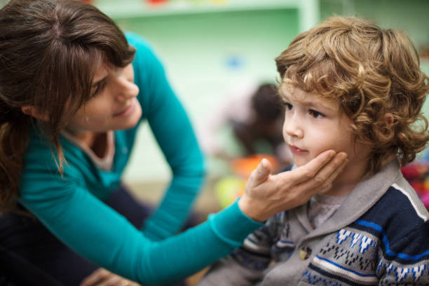 istock Teacher comforting upset boy in classroom 997549678