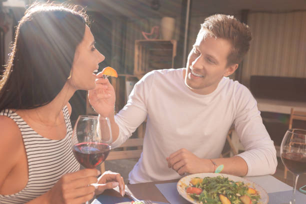 istock Caring beaming man giving fruits his girlfriend 997549796