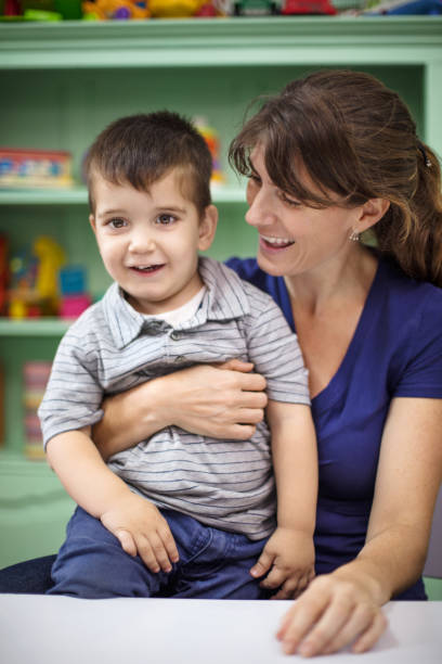 istock Teacher with student in preschool 997554268
