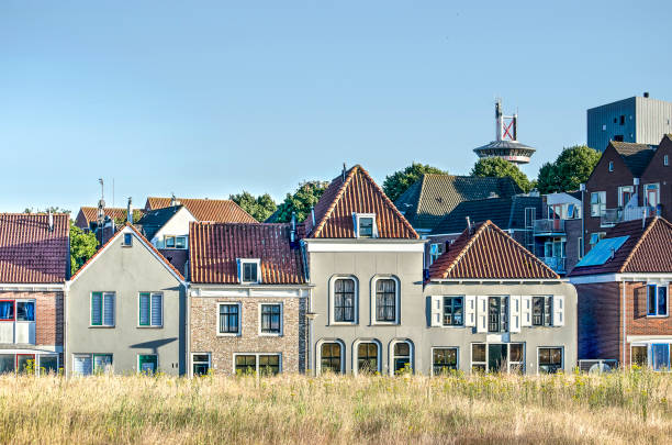 Vlissingen (Flushing), The Netherlands, July 2, 2018: row of houses overlooking an empty lot on the site of the former Schelde shipyard waiting for further development