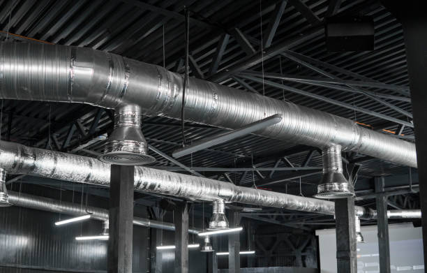 istock Ventilation system on the ceiling of large buildings. Ventilation pipes in silver insulation material hanging from the ceiling inside new building. 997562602
