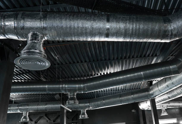 istock Ventilation system on the ceiling of large buildings. Ventilation pipes in silver insulation material hanging from the ceiling inside new building. 997563500