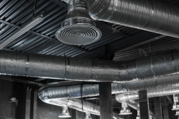 istock Ventilation system on the ceiling of large buildings. Ventilation pipes in silver insulation material hanging from the ceiling inside new building. 997563818