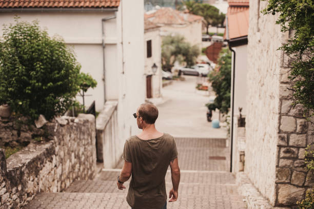 istock Man outdoors in sunny summer day with tank top and sunglasses 997567166