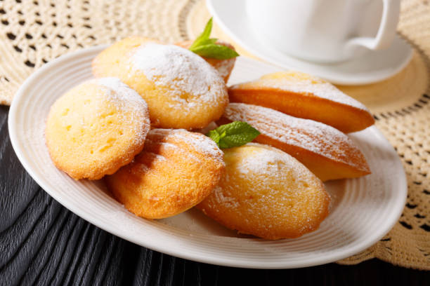 istock Elegant breakfast: Madeleine cookies with mint and tea close-up. horizontal 997568626