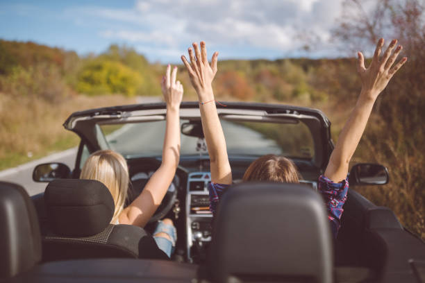 istock Young women on a road trip with cabriolet 997581394