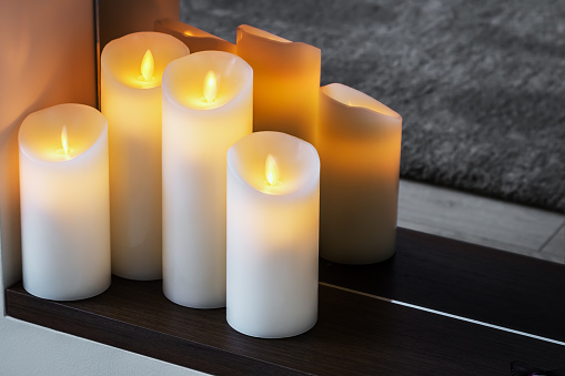 led electric candles stand in the home fireplace