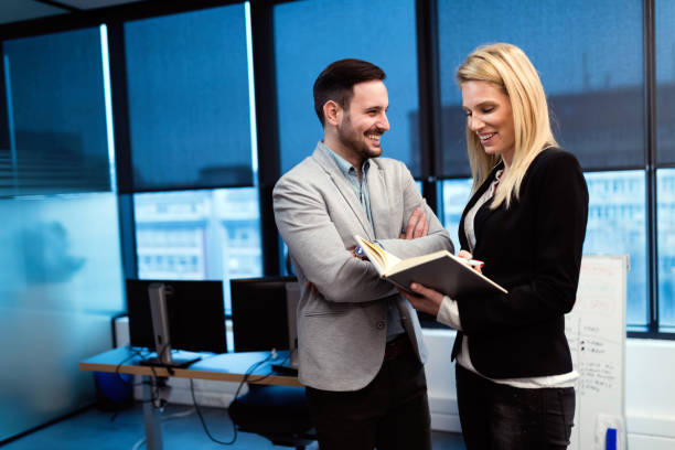 istock Business partners discussing financial report in office 997585060