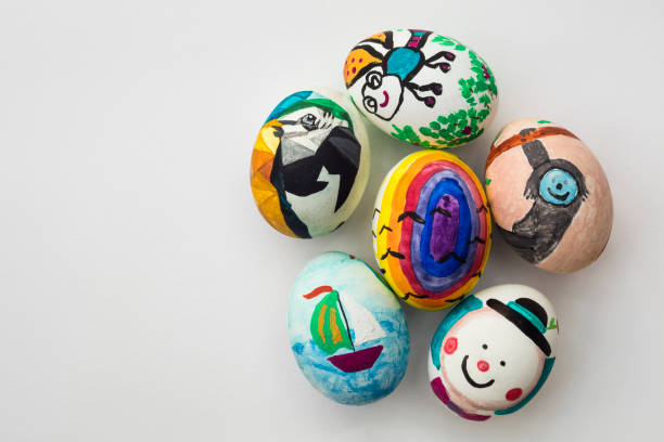 istock Detail of painted Easter eggs with different forms, cartoons and bright colors on isolated white background 997585168