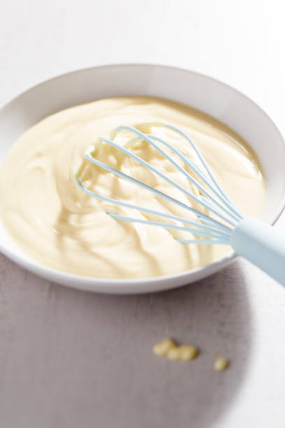 istock Bowl of vanilla custard with blue whisk 997585418