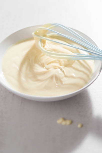 istock Bowl of vanilla custard with blue whisk 997585420