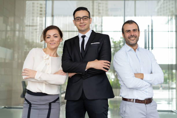 istock Cheerful entrepreneur and his smiling colleagues posing at camer 997586968