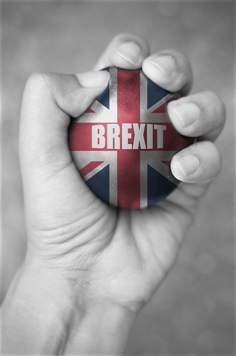 Hand squeezing a stress ball with brexit