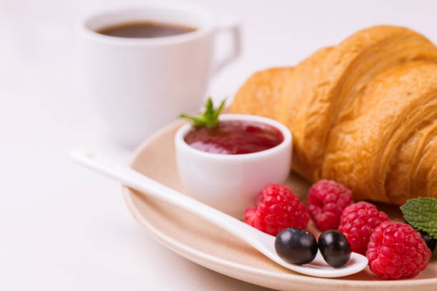 istock Coffee, fresh croissant with jam and berries for breakfast 997592670