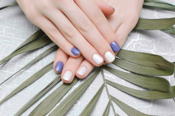 istock Female hands with blue nail design 997600958