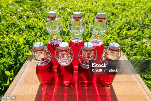 Glass Bottles Of Homemade Cherry Juice Stock Photo - Download Image Now - Austria, Bottle, Cherry