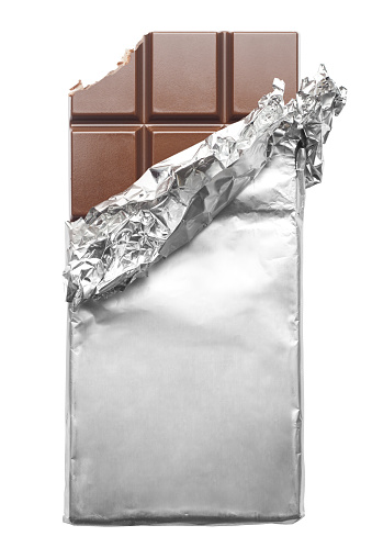 Chocolate wrapped in foil, bite, clipping path, isolated on white background