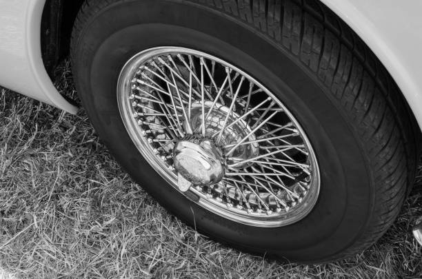 istock Classic car wire wheel in black and white 997606580