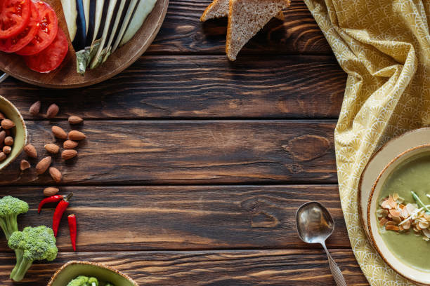 istock flat lay with arranged fresh vegetables and vegetarian cream soup with sprouts and almonds on wooden tabletop 997609036