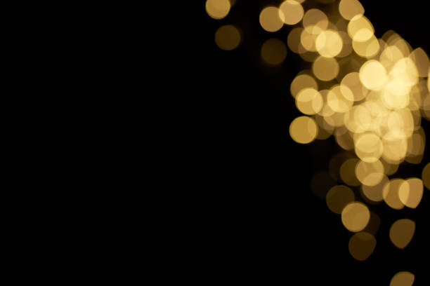 istock beautiful shiny defocused yellow bokeh on black background 997611828